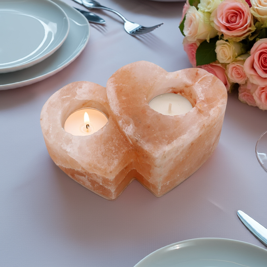 Double heart Himalayan salt candle holders on a dining table at a romantic dinner
