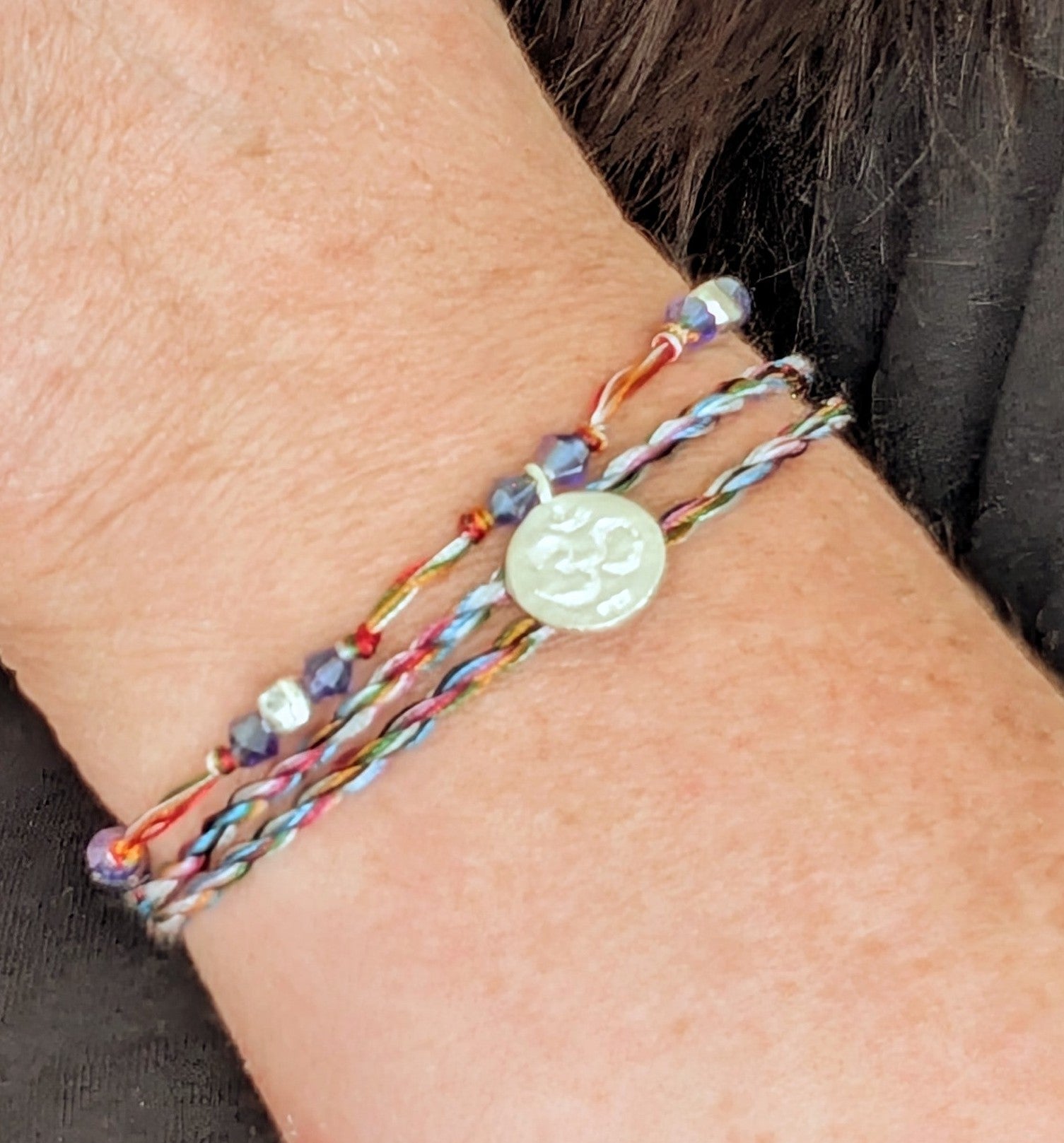 Close up of Om in serenity string bracelet, handmade in Indonesia