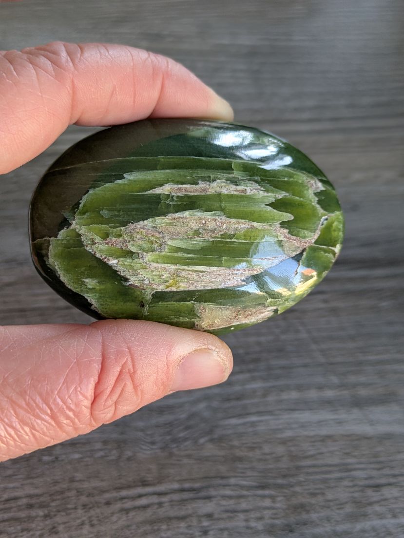 Vibrant green Tremolite Palmstone showing natural yellow bands for emotional balance