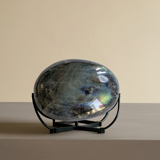 Madagascar Labradorite palm stone on stand, perfect for transformation meditation